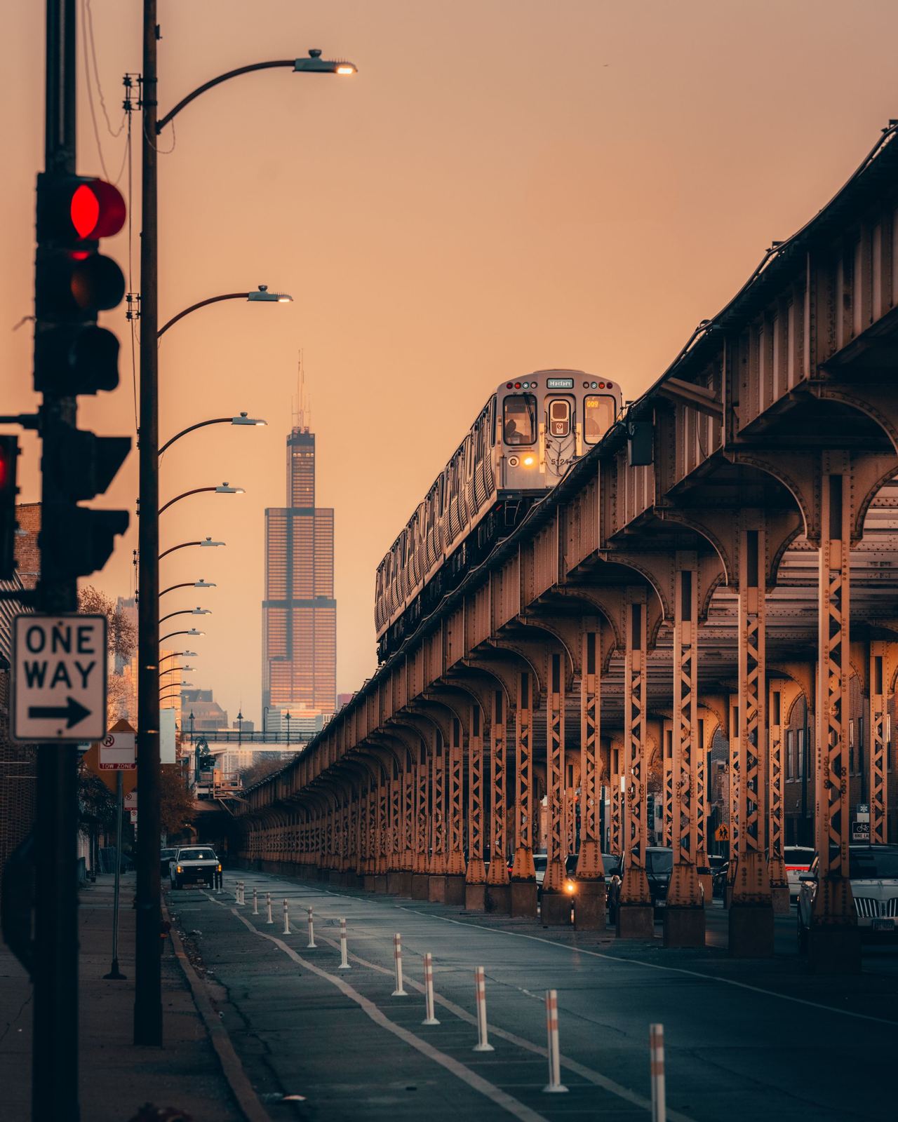 A Chicago L train on elevated tracks at dusk