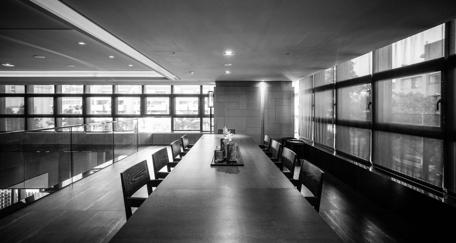 An empty conference room with a long wooden table