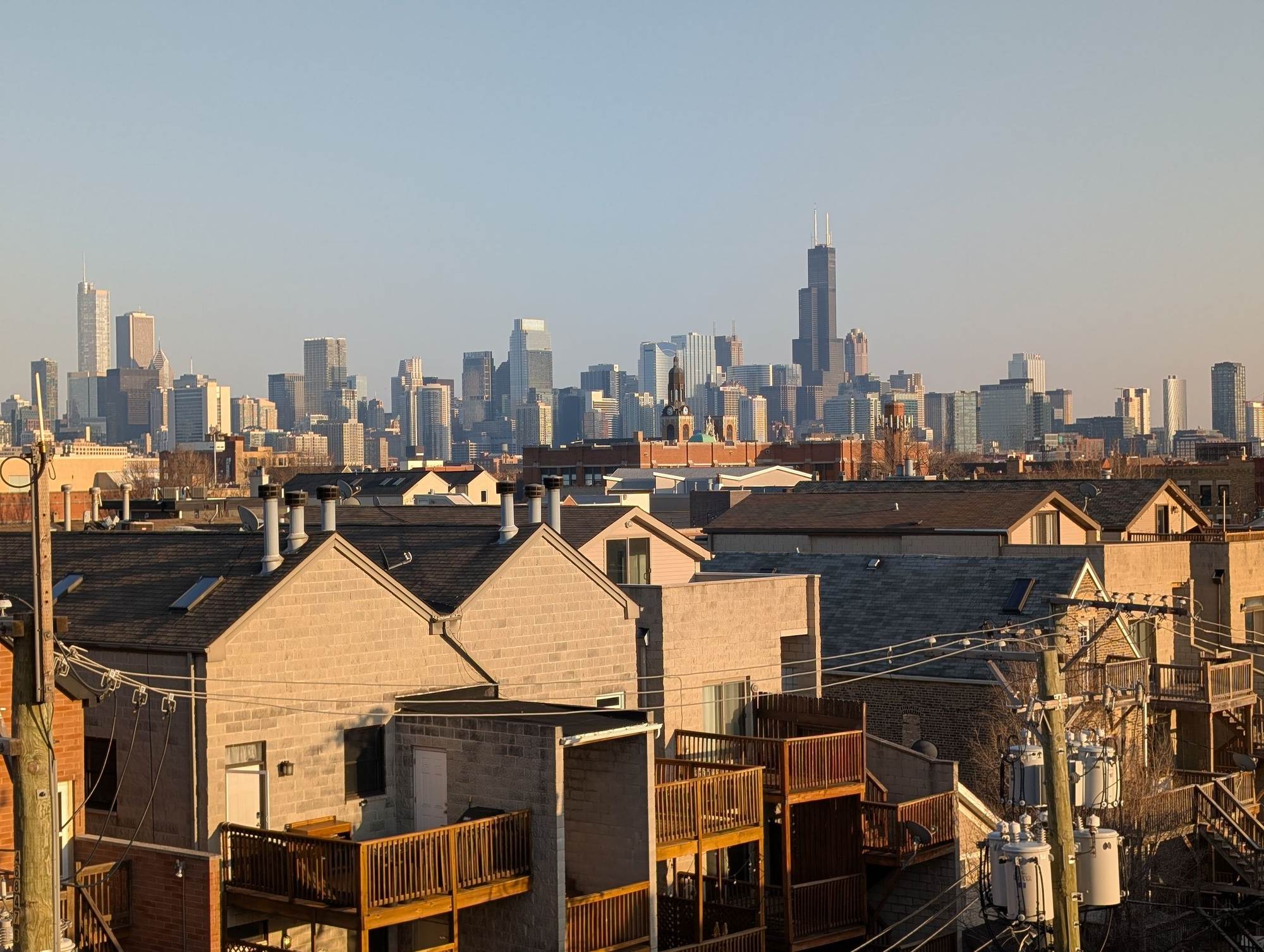 Chicago neighborhood rooftops and back porches with the downtown skyline behind