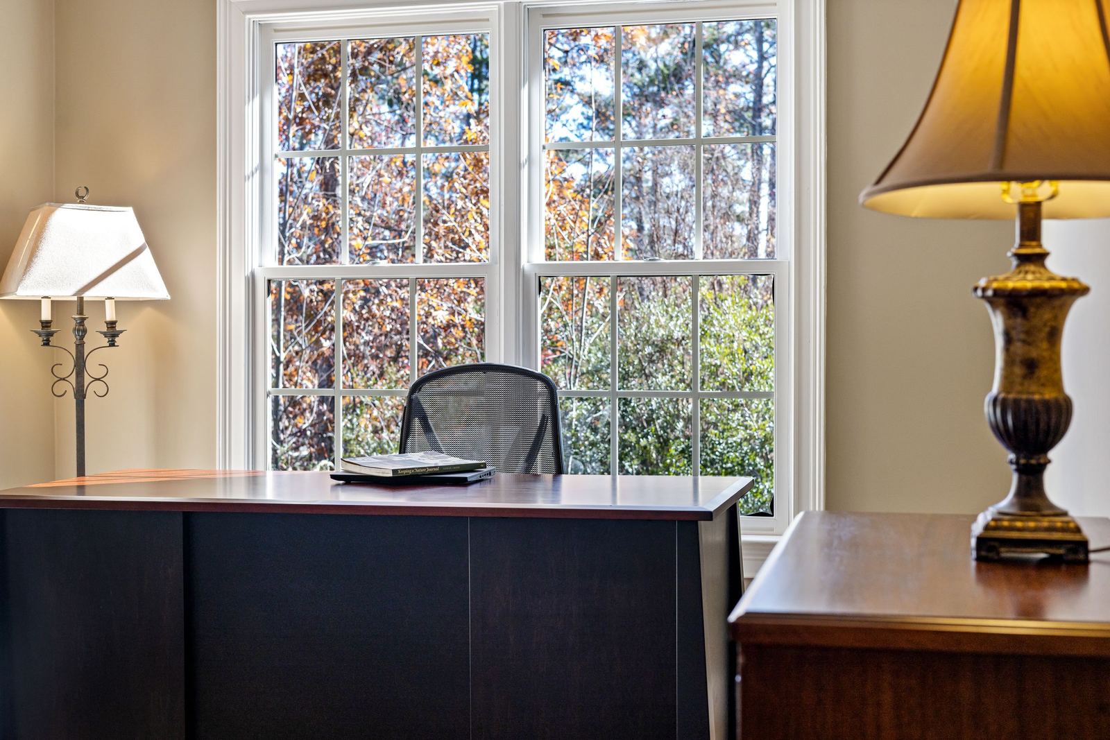 A quiet office with a wooden desk by a window